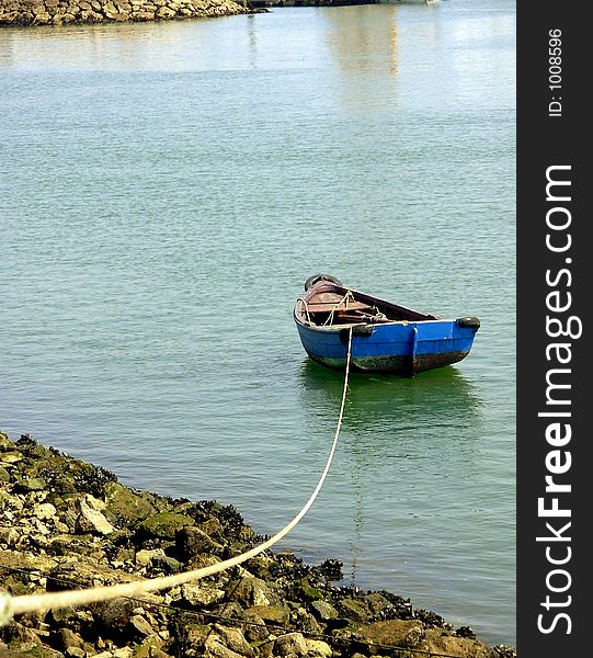 Cockle-boat of fishes moored to the edge of the marina of Lagos.Algarve,Portugal It seems to invite to give us to it a return for laughs so calm.