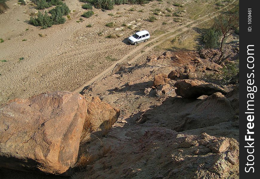 Offroader in a valley in the near of the brandberg in namibia. This is the valley of the desert elephants. Offroader in a valley in the near of the brandberg in namibia. This is the valley of the desert elephants.