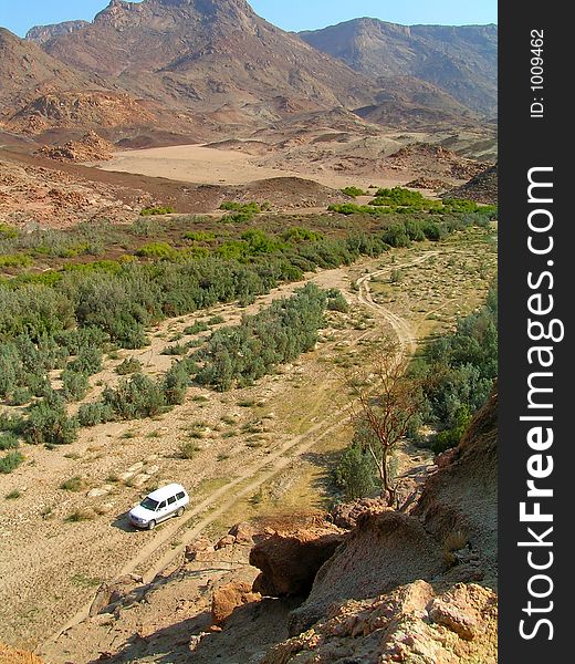 The offroader stands in the valley of the desert elephants near of brandberg range in namibia,. The offroader stands in the valley of the desert elephants near of brandberg range in namibia,