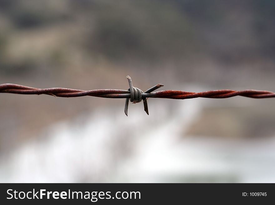 Image of two strands of wire used to keep stock behind a fence. Taken in the Australian bush, west of The Great Dividing Range. Image of two strands of wire used to keep stock behind a fence. Taken in the Australian bush, west of The Great Dividing Range