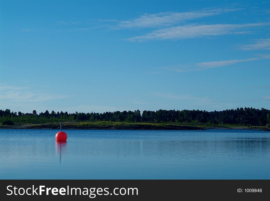 Orange Buoy In Calm Waters