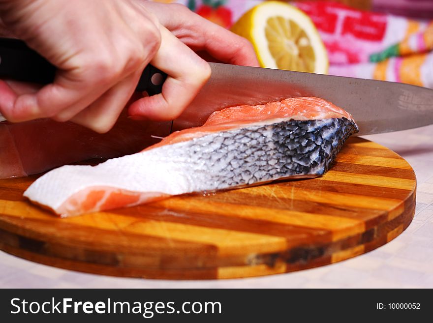 Fresh slice of salmon with lemon on the wood board