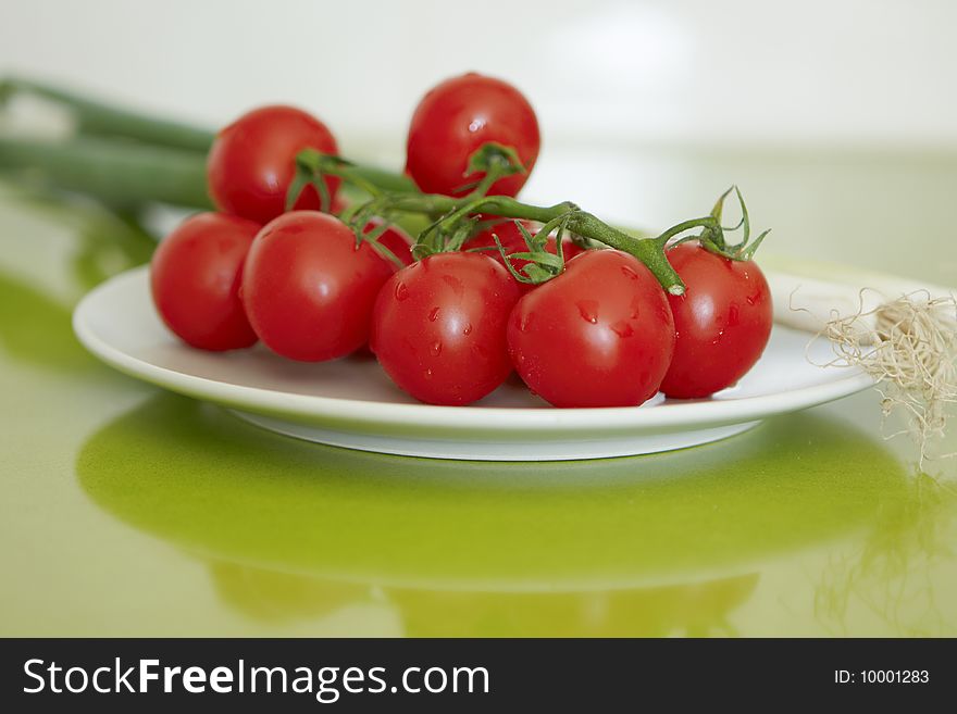 Appetizing red cherry tomatoes with leek