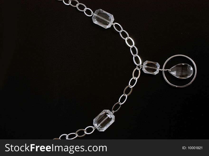 Costume jewellery of silvery color on black background