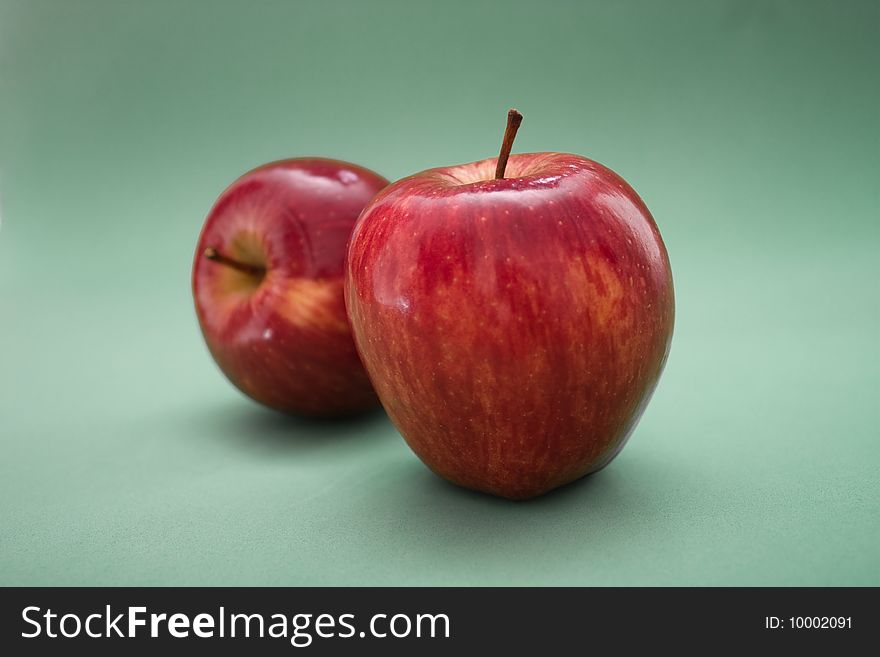 Two red apples on a gray background. Two red apples on a gray background