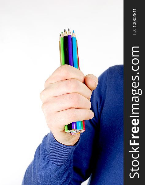 This is an image of a man holding a bunch of color pencils. This is an image of a man holding a bunch of color pencils.