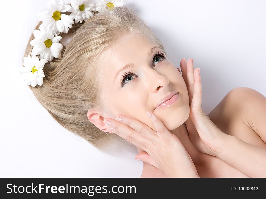 Close-up beautiful fresh blond lady with camomiles in her hair. Close-up beautiful fresh blond lady with camomiles in her hair