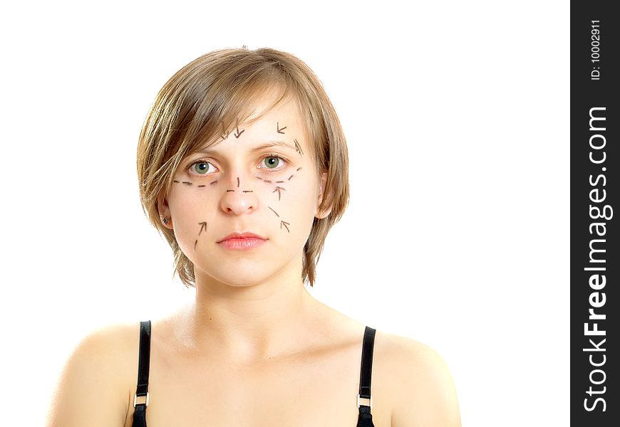 Closeup portrait of an attractive Caucasian girl whose face is marked with lines and arrows for facial cosmetic surgery. Isolated on white. Closeup portrait of an attractive Caucasian girl whose face is marked with lines and arrows for facial cosmetic surgery. Isolated on white.