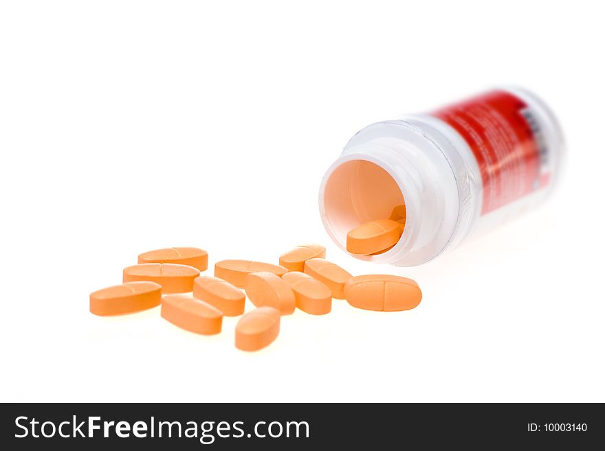 Tablets with a jar on a white background