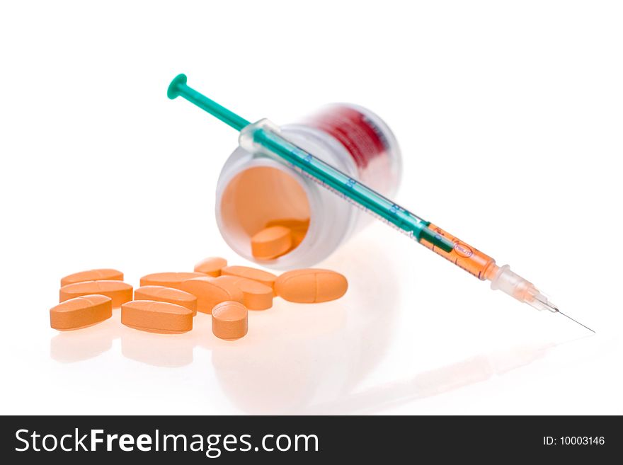 Syringe with a medicine and tablets. Syringe with a medicine and tablets
