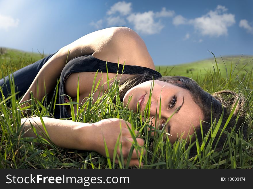 Field with a lying attractive young girl. Field with a lying attractive young girl