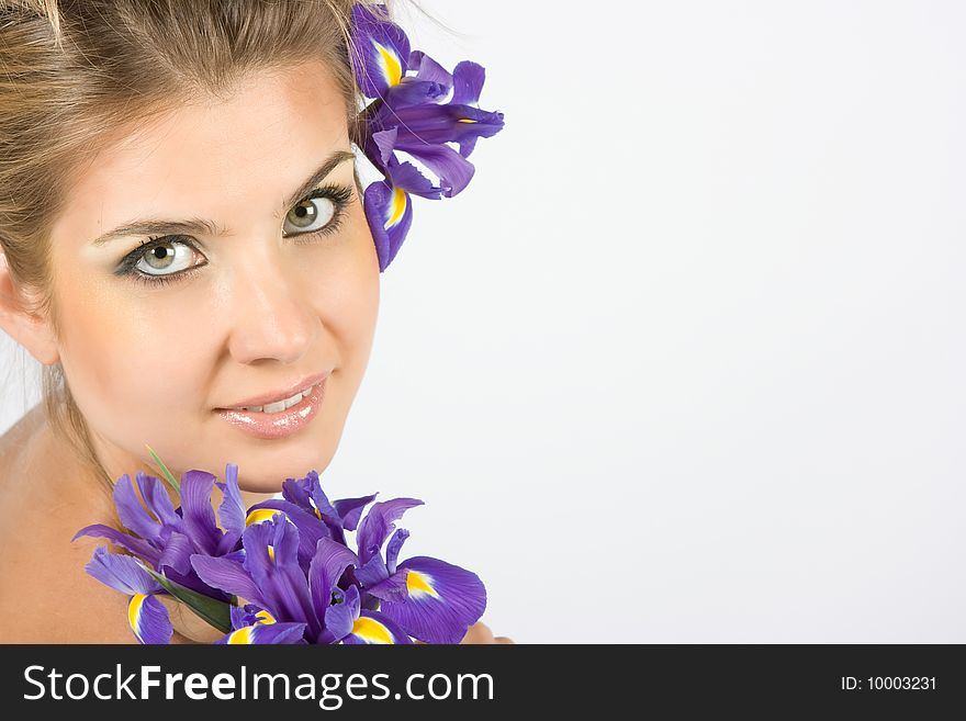 Close-up fresh funny blonde with beautiful make-up with iris flowers. Close-up fresh funny blonde with beautiful make-up with iris flowers