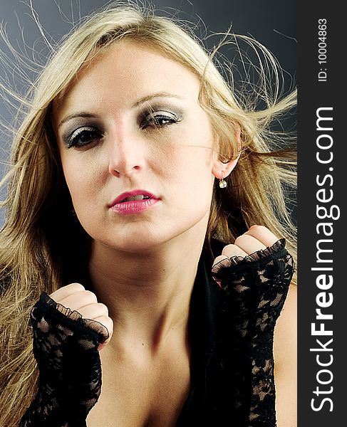 Great looking female model ready for a fight with her lace gloves. Great looking female model ready for a fight with her lace gloves.