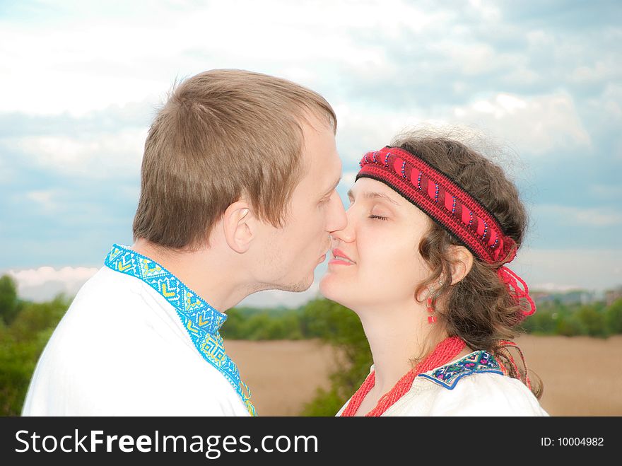 Young boy kissing a girl at sunset. Young boy kissing a girl at sunset