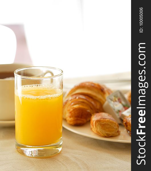 Breakfast with orange-juice, croissant and coffee