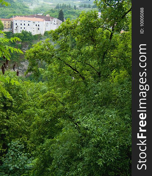 View through rainy forest to a castle on the rock Location: Pazin Castle, Istria, Croatia, Europe *with space for text (copyspace) **RAW format available. View through rainy forest to a castle on the rock Location: Pazin Castle, Istria, Croatia, Europe *with space for text (copyspace) **RAW format available