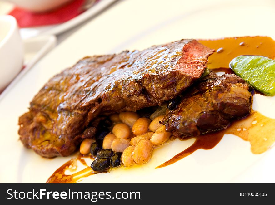 Sirloin strip Steak with green Beans ,vegetables and savory sauce.