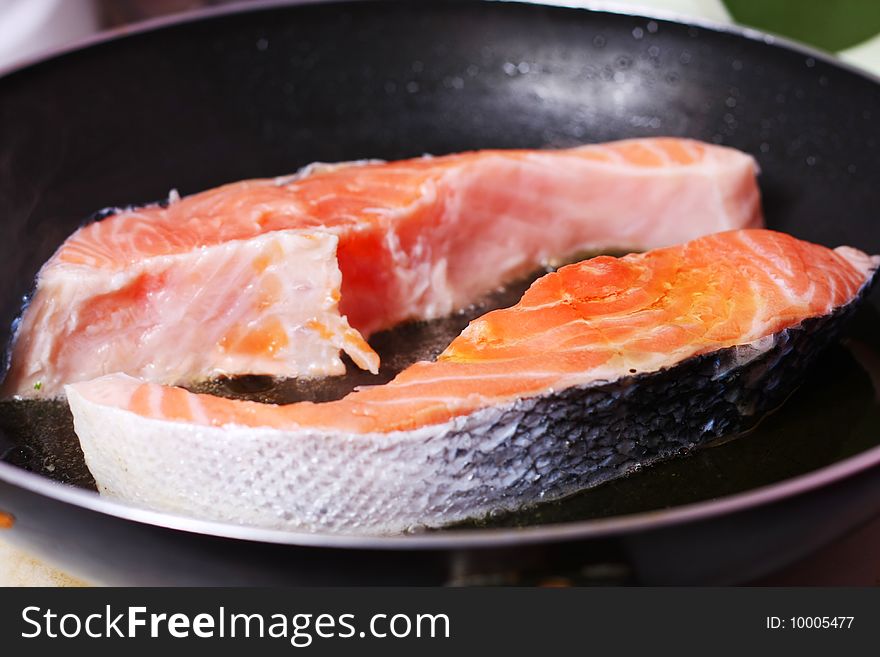 Fresh slice of salmon in the frying pan