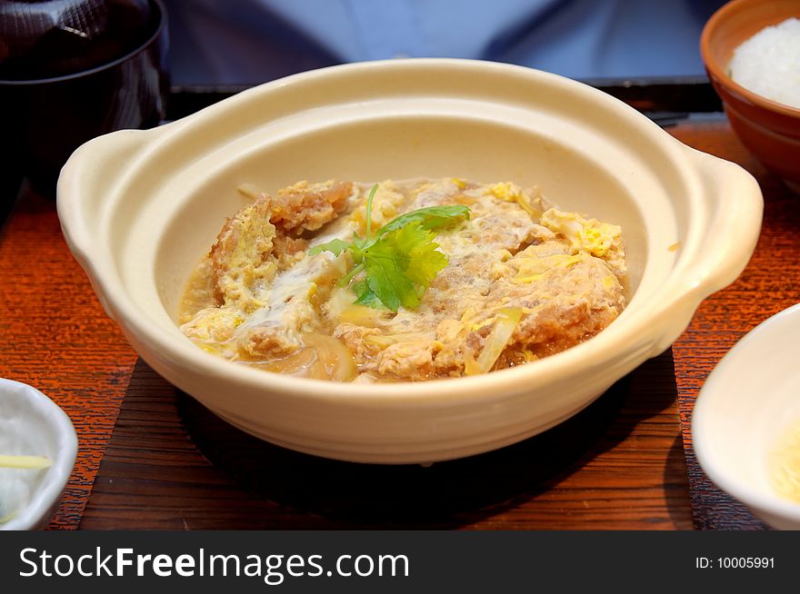 Japanese fried pork chop omelet and rice cooked in claypot