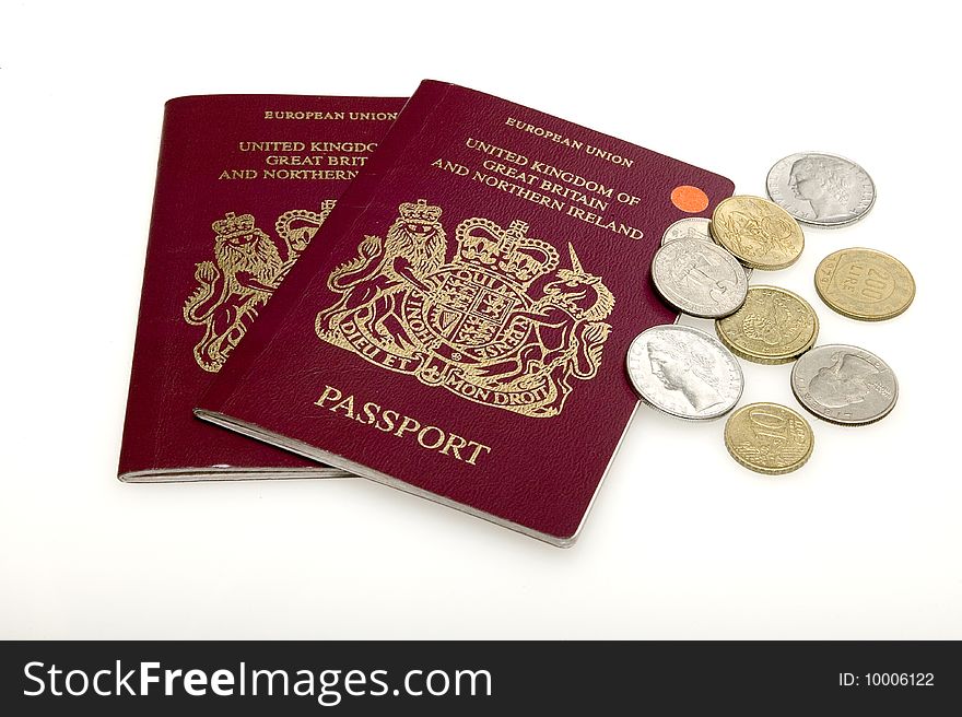 View of two British Passports and a selection of coins. View of two British Passports and a selection of coins