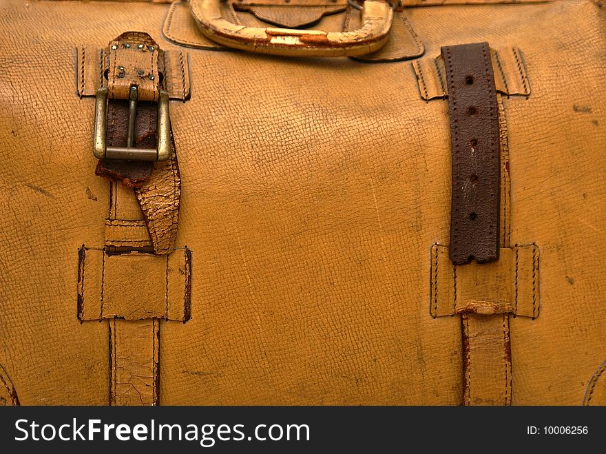 Close up detail of old lcracked eather suitcase with straps. Close up detail of old lcracked eather suitcase with straps.