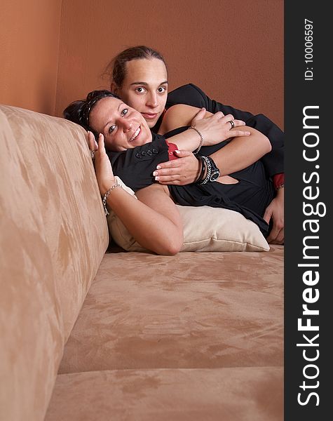 Portrait of a cute young couple enjoying themselves on a couch. Portrait of a cute young couple enjoying themselves on a couch.