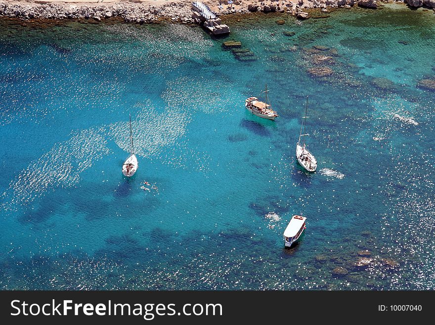 Some sailing ships in the amazing cyan colored ionian sea. Some sailing ships in the amazing cyan colored ionian sea.