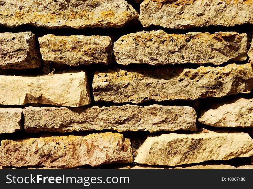 Old weathered stone wall in park. Old weathered stone wall in park