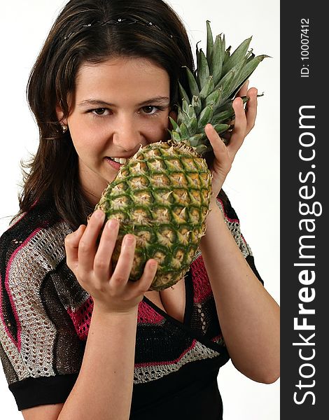 Smiling girl with pineapple on white background