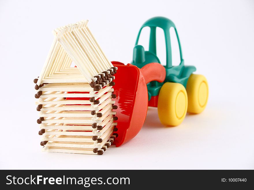 Children's tractor a transporting match small house. Children's tractor a transporting match small house