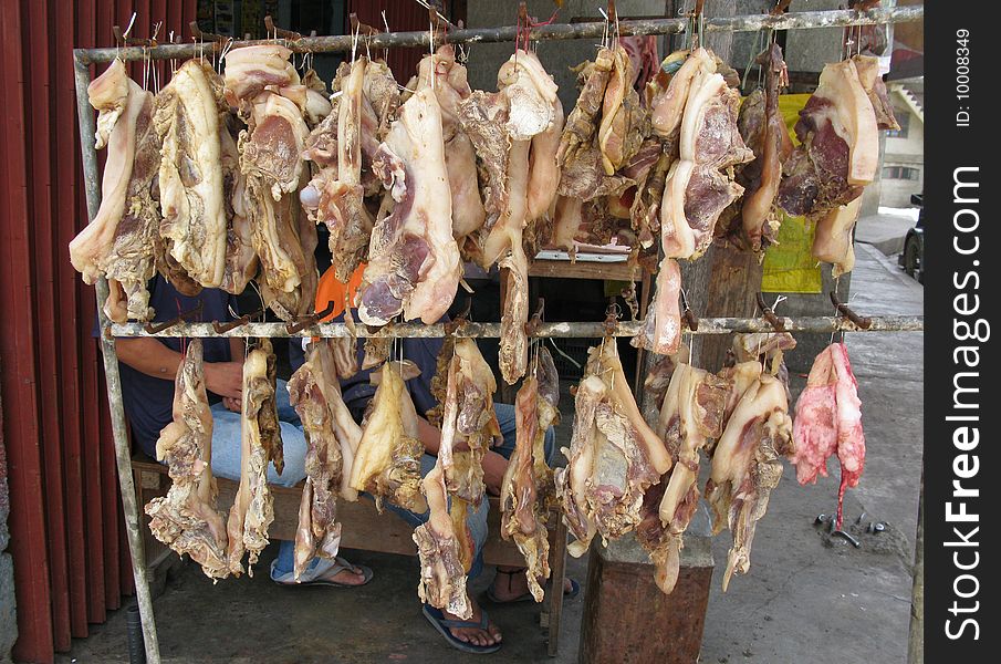 Typical butcher's stall with hanging lines of fat and lean meat. Philippines. Typical butcher's stall with hanging lines of fat and lean meat. Philippines