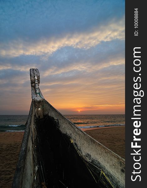 Fishing Boat on Beach at Sunset