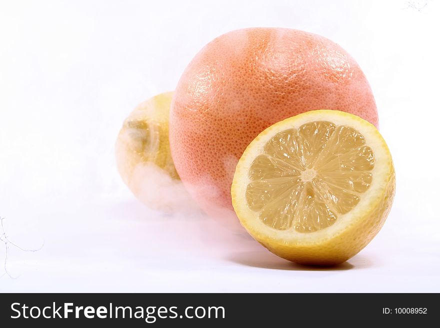 Orange and lemon in smoke that suggests freezing. Orange and lemon in smoke that suggests freezing