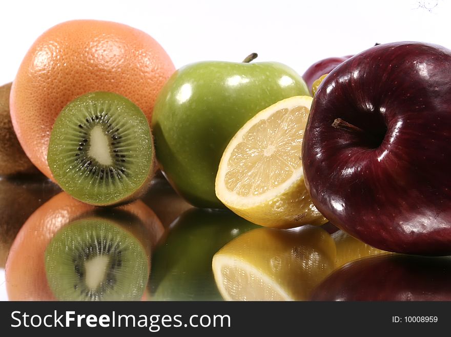 Assorted fruits with their reflection