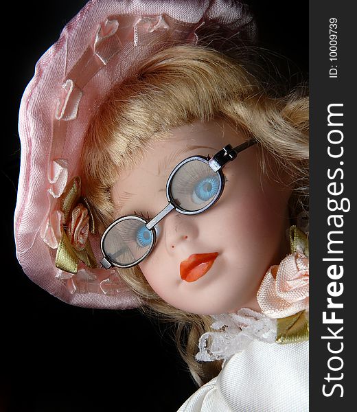 Detail head ceramic dolls with glasses and pink cap, blue-eyed doll