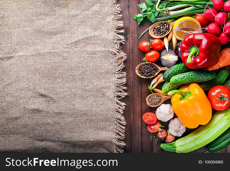 Frame of organic food. Fresh raw vegetables and spices. On a wooden chalkboard.