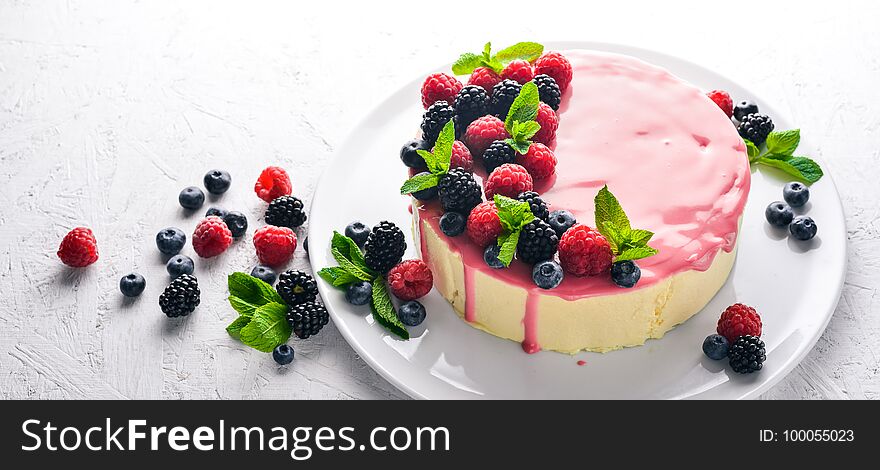 Cake with butter and fresh berries and fruits. Dessert. On a wooden background