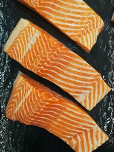 Salmon Fillet In Front Of Black Background Stock Images