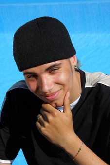 Smiling Teenager Sitting At Swimming Pool Royalty Free Stock Image