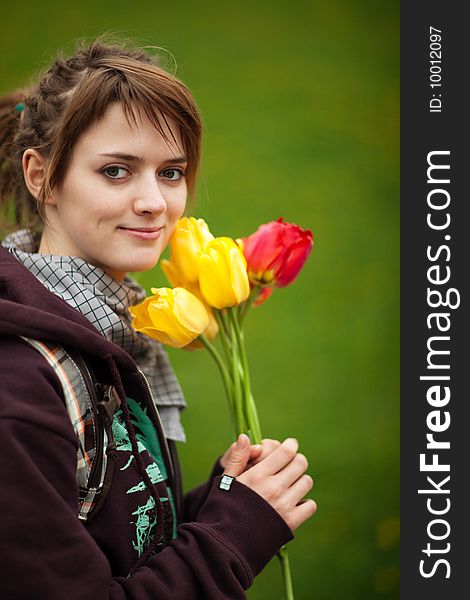 Portrait of a pretty young girl with a bouquet of tulips - shallow DOF. Portrait of a pretty young girl with a bouquet of tulips - shallow DOF