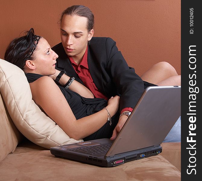 Young couple on the couch surfing the web with their laptop. Young couple on the couch surfing the web with their laptop.