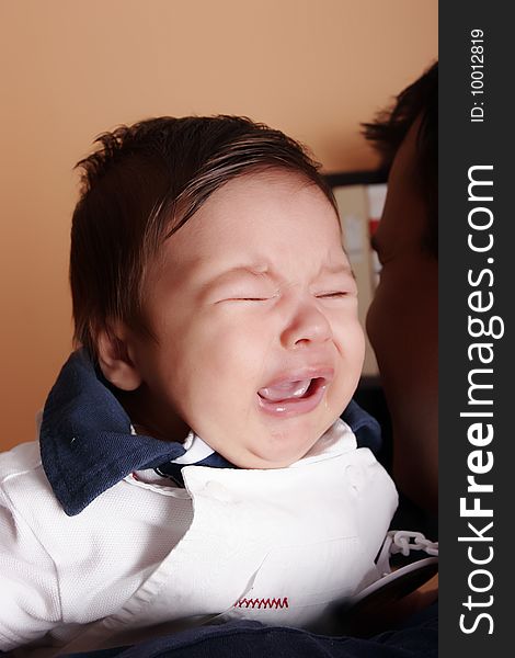 New born baby crying at father's shoulder. New born baby crying at father's shoulder