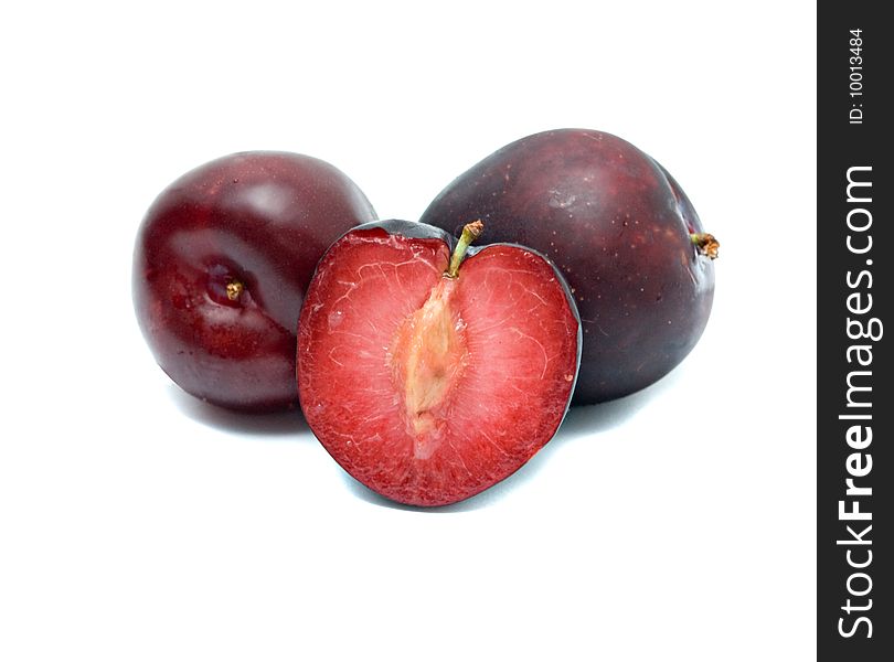 Plums and section isolated on white background