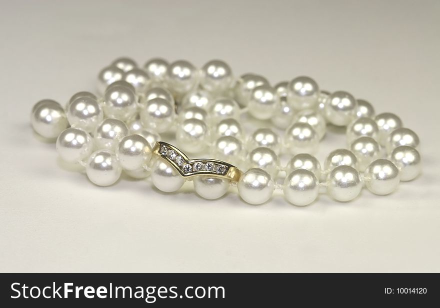 String of pearls with a wishbone diamond engagement ring. String of pearls with a wishbone diamond engagement ring