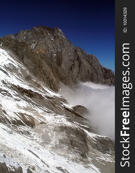 Snow covered mountain with a deep bule sky