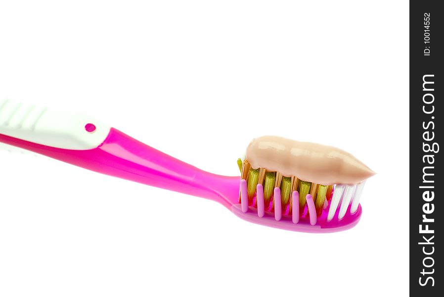 Close-up of a toothbrush with paste isolated on white background