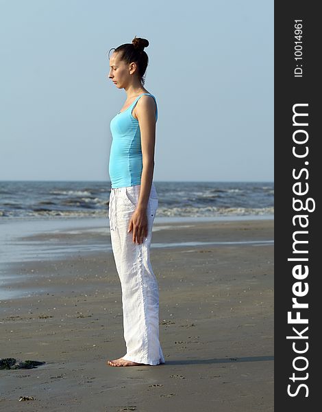 Woman doing breathing exercises at the beach. Woman doing breathing exercises at the beach