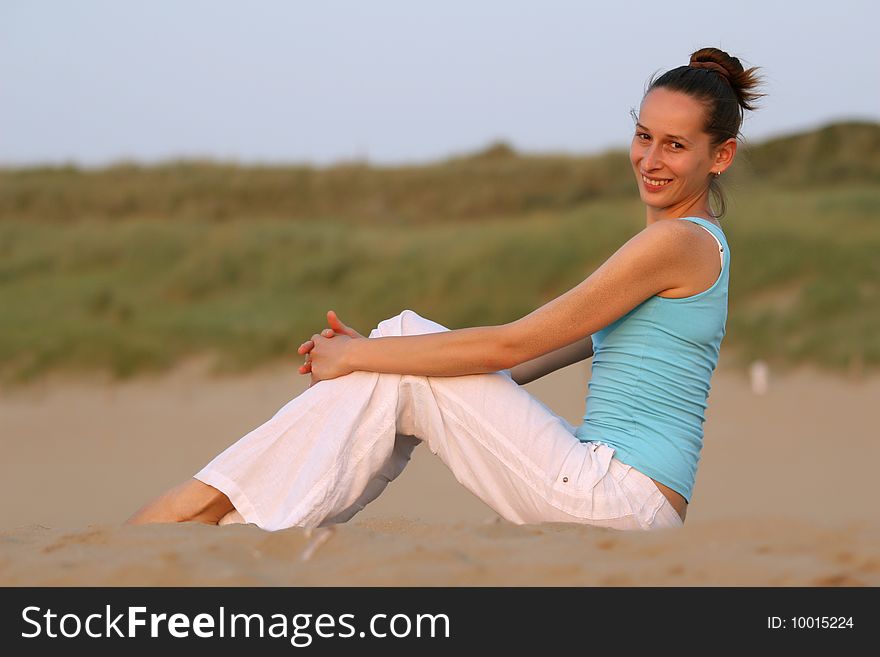 Woman relaxing after workout on the beach. Woman relaxing after workout on the beach