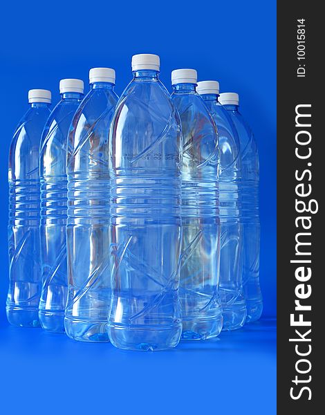 Mineral water bottle isolated on blue background, close up. Mineral water bottle isolated on blue background, close up