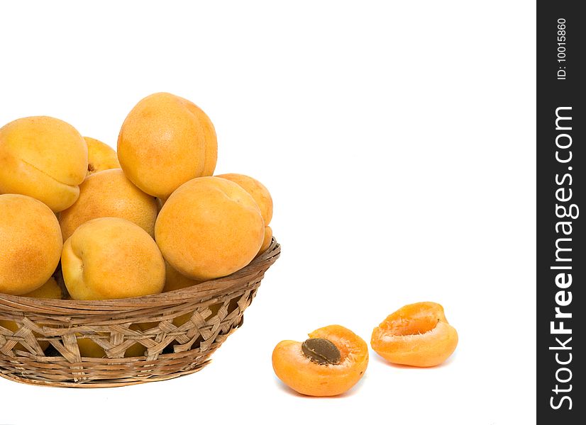 Basket with pile of apricots isolated on white background